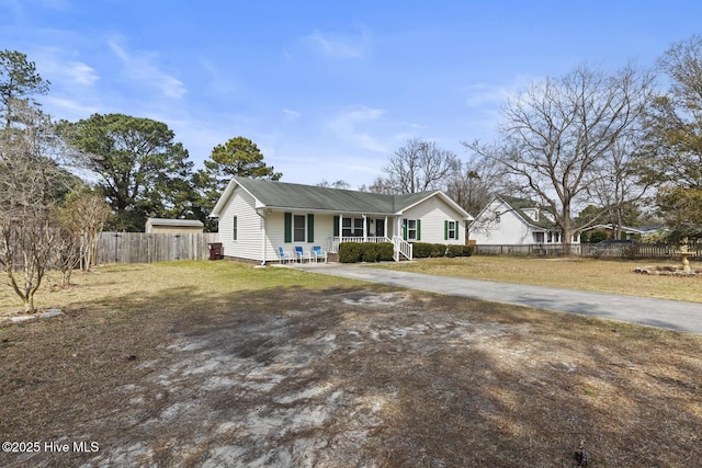 view of front of house with crawl space, a porch, a front lawn, and fence