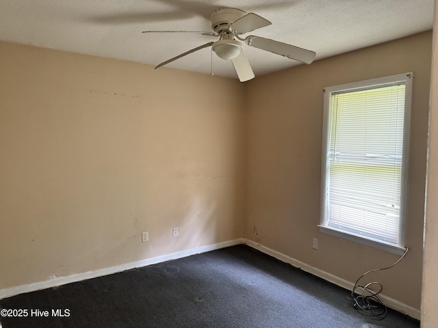 1122 E Stewart Cir, Wilmington, NC 28405 - unfurnished room featuring healthy amount of natural light, dark carpet, a ceiling fan, and baseboards