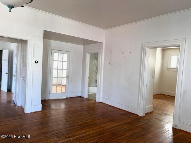 unfurnished room with wood finished floors and crown molding