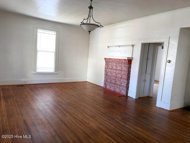 interior space featuring baseboards and wood finished floors