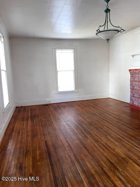 empty room with baseboards and wood finished floors