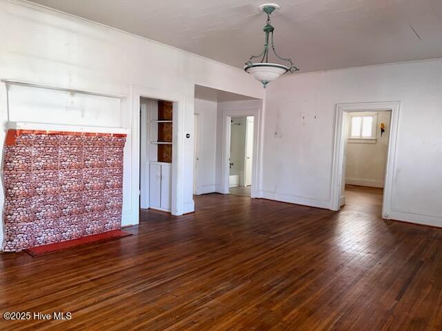 unfurnished room with baseboards and wood finished floors