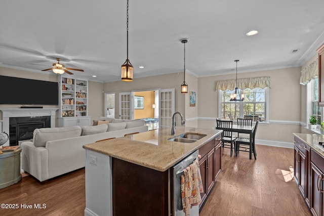 kitchen featuring a sink, ornamental molding, ceiling fan with notable chandelier, stainless steel dishwasher, and dark wood-style flooring