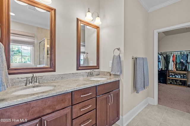 full bathroom with tile patterned flooring, double vanity, ornamental molding, and a sink