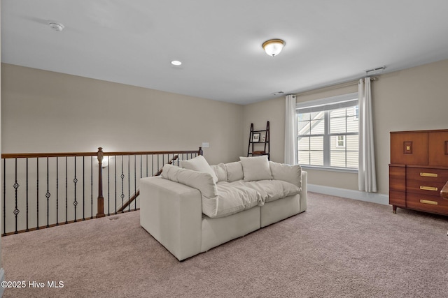 carpeted living area featuring recessed lighting, visible vents, and baseboards