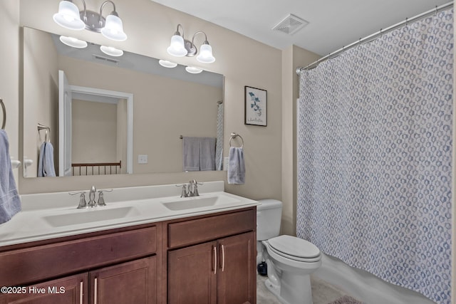 bathroom with toilet, visible vents, and a sink