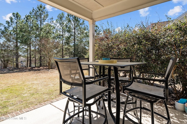 view of patio with outdoor dining space and fence