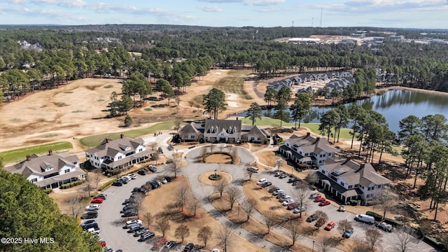 bird's eye view featuring a wooded view and a water view