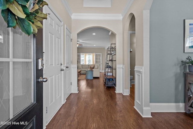 foyer entrance featuring ceiling fan, ornamental molding, and dark wood finished floors