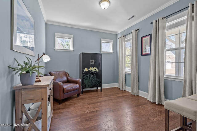 sitting room with visible vents, a healthy amount of sunlight, wood finished floors, and crown molding