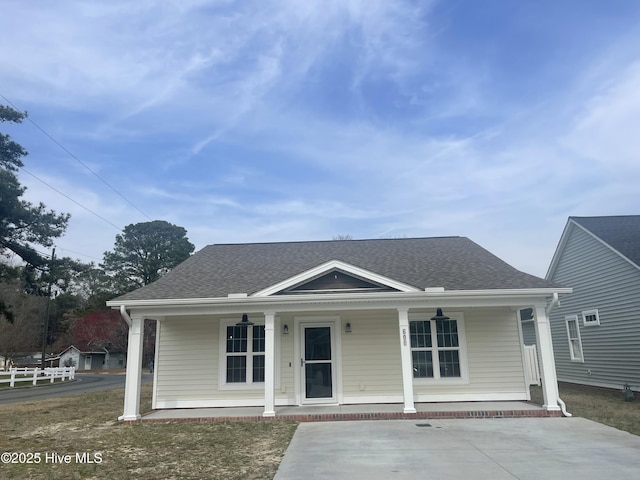 bungalow-style home with a porch and a shingled roof