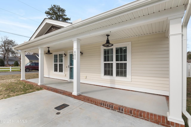 view of exterior entry with covered porch