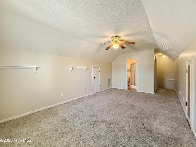 bonus room with visible vents, a ceiling fan, a textured ceiling, carpet floors, and vaulted ceiling