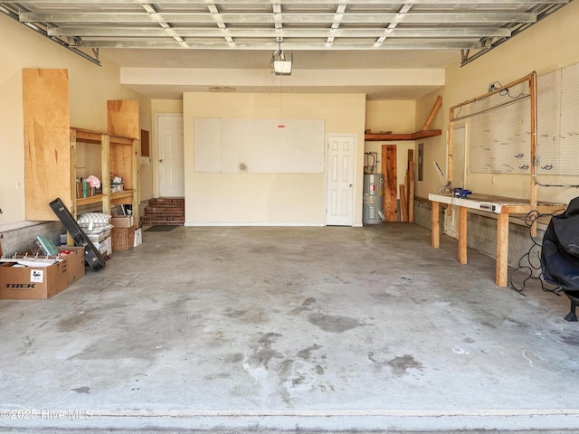 garage featuring a workshop area, electric water heater, and a garage door opener