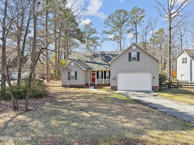 traditional home with a porch, driveway, a front lawn, and fence