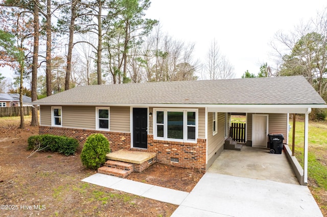 single story home featuring driveway, roof with shingles, crawl space, an attached carport, and brick siding