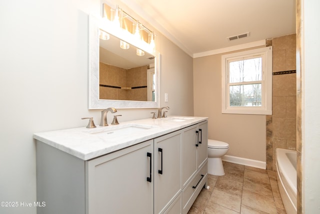 bathroom featuring double vanity, toilet, visible vents, and a sink