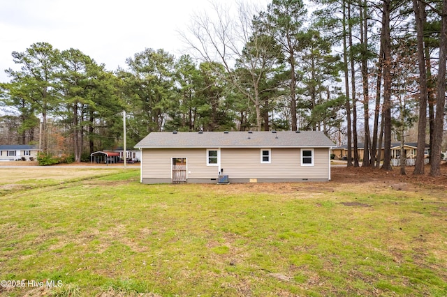 back of house featuring crawl space and a yard