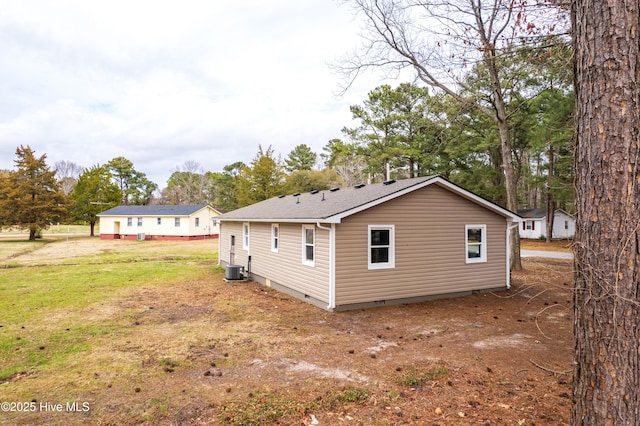 exterior space featuring crawl space, central air condition unit, and a lawn