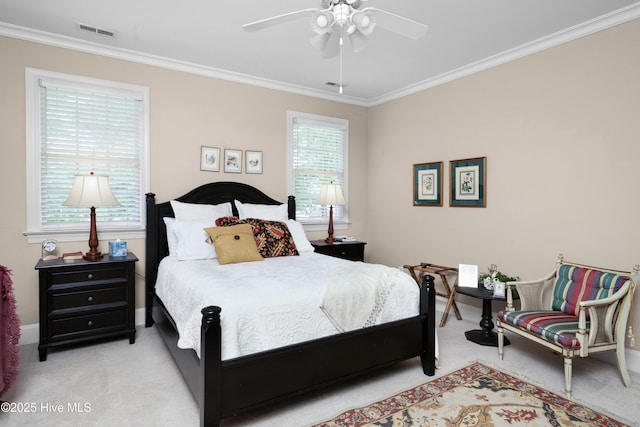 carpeted bedroom featuring visible vents, ceiling fan, and crown molding
