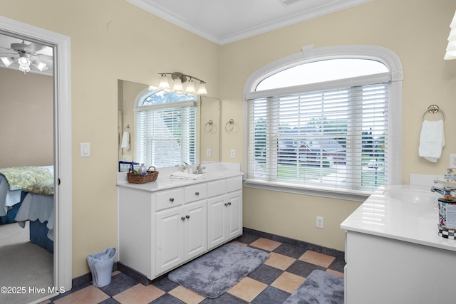 ensuite bathroom with crown molding, ceiling fan, ensuite bathroom, baseboards, and vanity