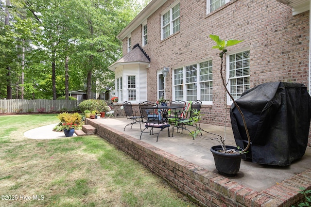 exterior space featuring grilling area and fence