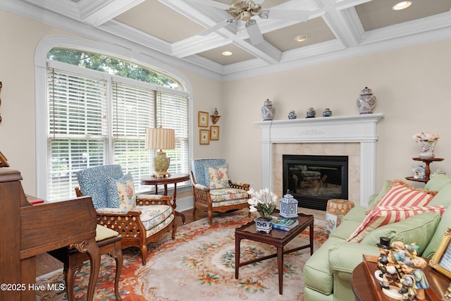 living room featuring beamed ceiling, recessed lighting, a tile fireplace, coffered ceiling, and a ceiling fan