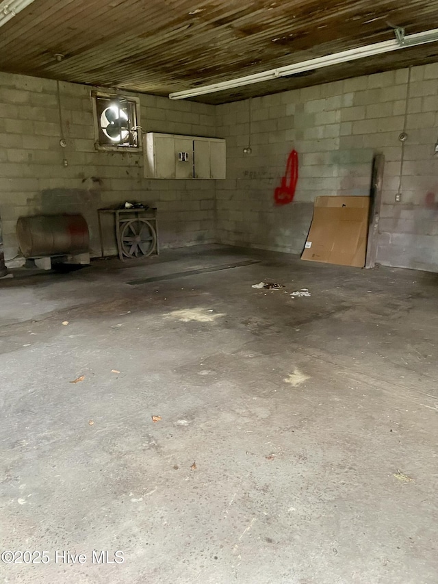 garage featuring concrete block wall and heating fuel