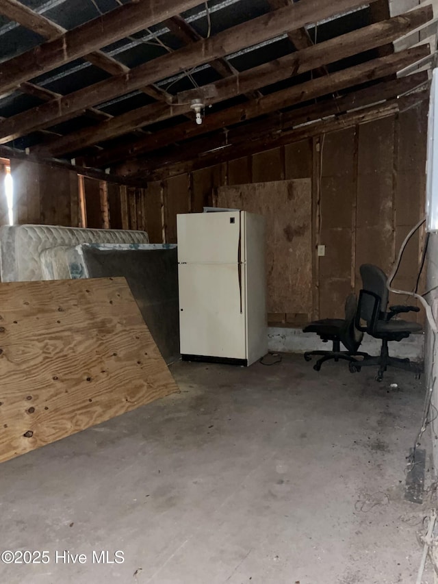 below grade area with freestanding refrigerator