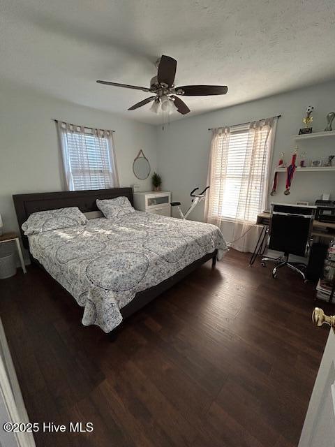 bedroom featuring ceiling fan, a textured ceiling, and wood finished floors