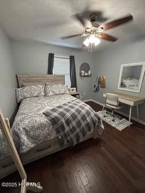 bedroom featuring baseboards, a textured ceiling, wood finished floors, and a ceiling fan