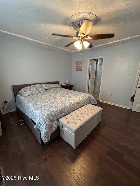 bedroom with dark wood-style floors, baseboards, a textured ceiling, and ceiling fan