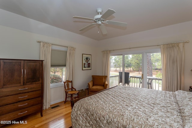 bedroom featuring access to outside, multiple windows, visible vents, and light wood-type flooring