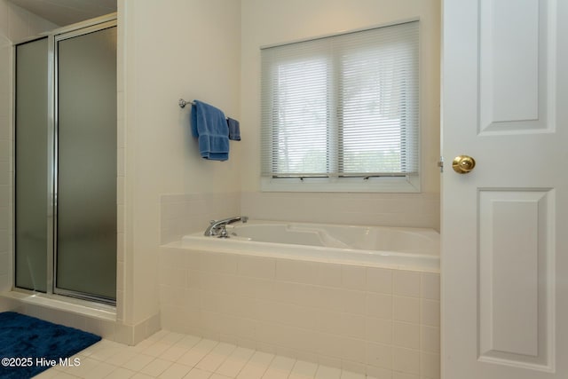 full bathroom featuring tile patterned floors, a stall shower, and a garden tub