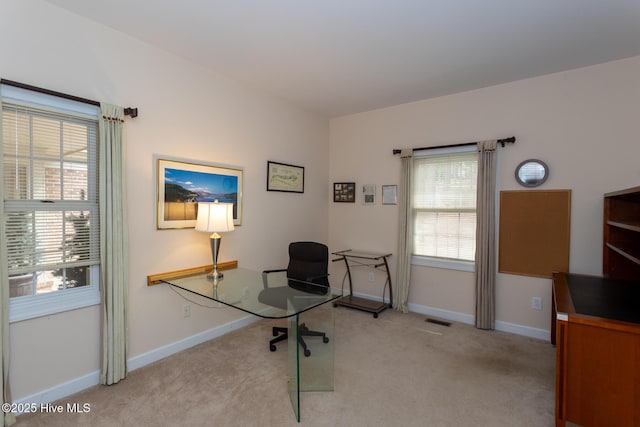 home office with visible vents, light colored carpet, and baseboards