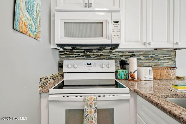 kitchen with white cabinetry, white appliances, light stone countertops, and backsplash