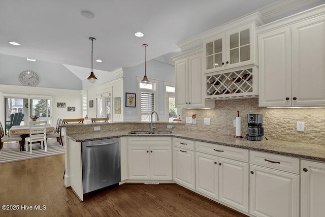 kitchen with a sink, dishwasher, a peninsula, white cabinetry, and dark wood-style flooring