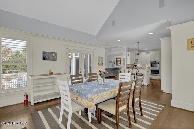 dining area with dark wood finished floors, recessed lighting, french doors, and high vaulted ceiling