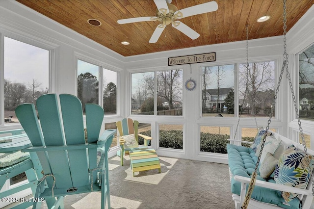 sunroom / solarium with wooden ceiling and a ceiling fan