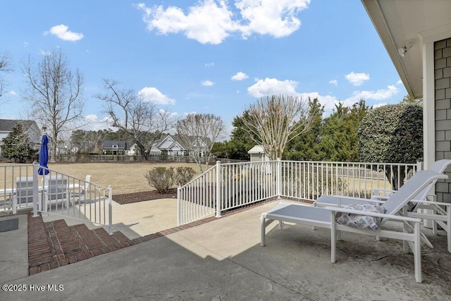 view of patio / terrace featuring an outbuilding and fence