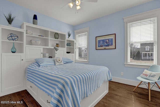 bedroom with dark wood finished floors, a ceiling fan, and baseboards