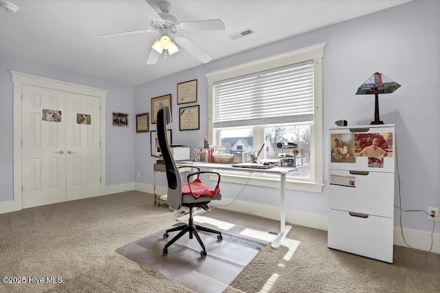 office area with visible vents, baseboards, ceiling fan, and carpet flooring