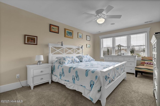 carpeted bedroom with visible vents, baseboards, and a ceiling fan