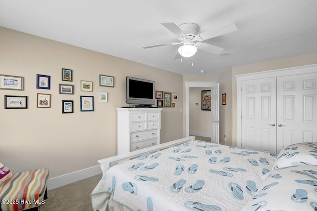 carpeted bedroom featuring a closet, baseboards, and ceiling fan