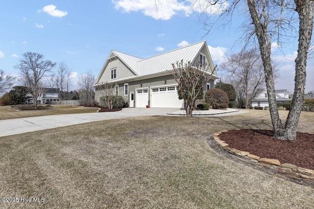 view of side of property featuring a lawn, board and batten siding, concrete driveway, and metal roof