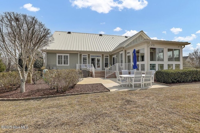 back of house with a patio area and a sunroom