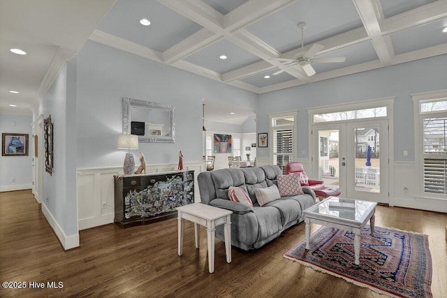 living room featuring beamed ceiling, coffered ceiling, and wood finished floors