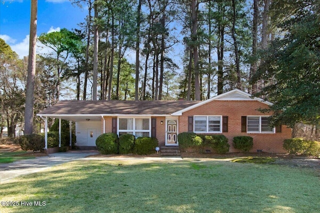 ranch-style house featuring brick siding, an attached carport, a front yard, crawl space, and driveway