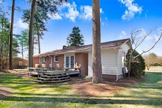 back of house with a yard, french doors, and a deck