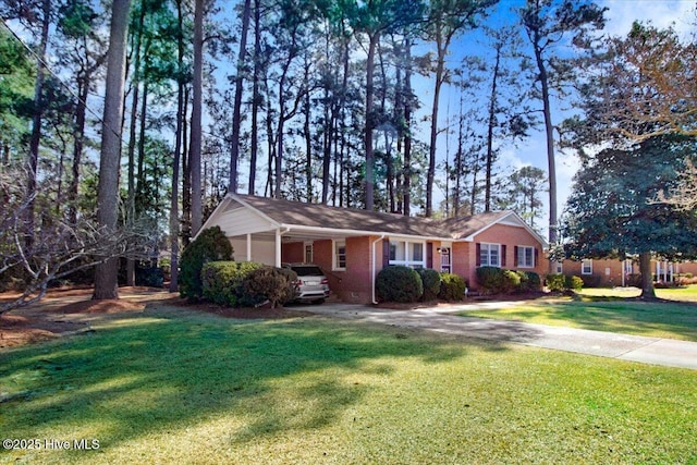 view of front of property featuring a carport, concrete driveway, a front lawn, and brick siding